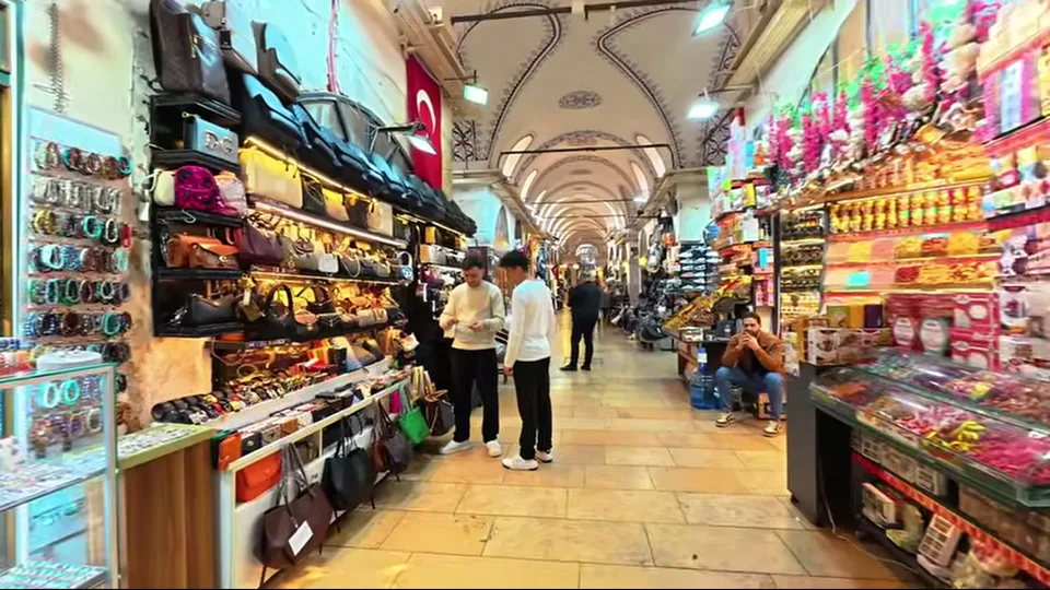 Glowing mosaic lamp stall in the Grand Bazaar beside a vaulted arcade