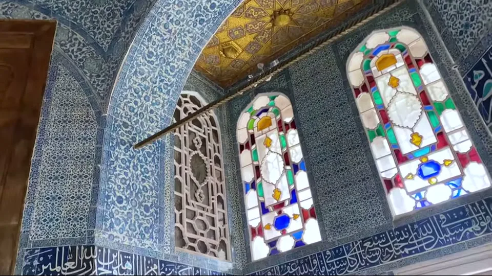 Grand ornate Harem hall with columns, sofas, and giant vases